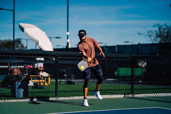 Joueur de pickleball exécutant un drop shot pour envoyer la balle doucement dans la cuisine