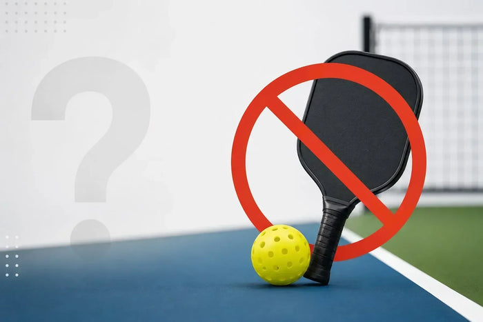 Raquette de pickleball noire et balle jaune devant un symbole d'interdiction sur un terrain de pickleball, illustrant les situations où la pratique du pickleball n'est pas recommandée.